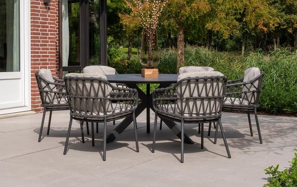 Teakhouten tuintafel met stoelen en planten op een terras in de tuin